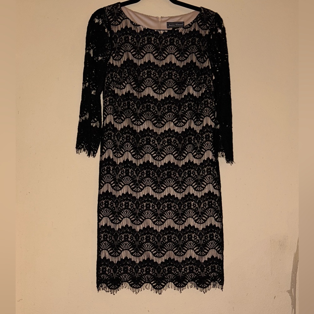 Jessica Howard black Lace over a nude lining in a midi length.